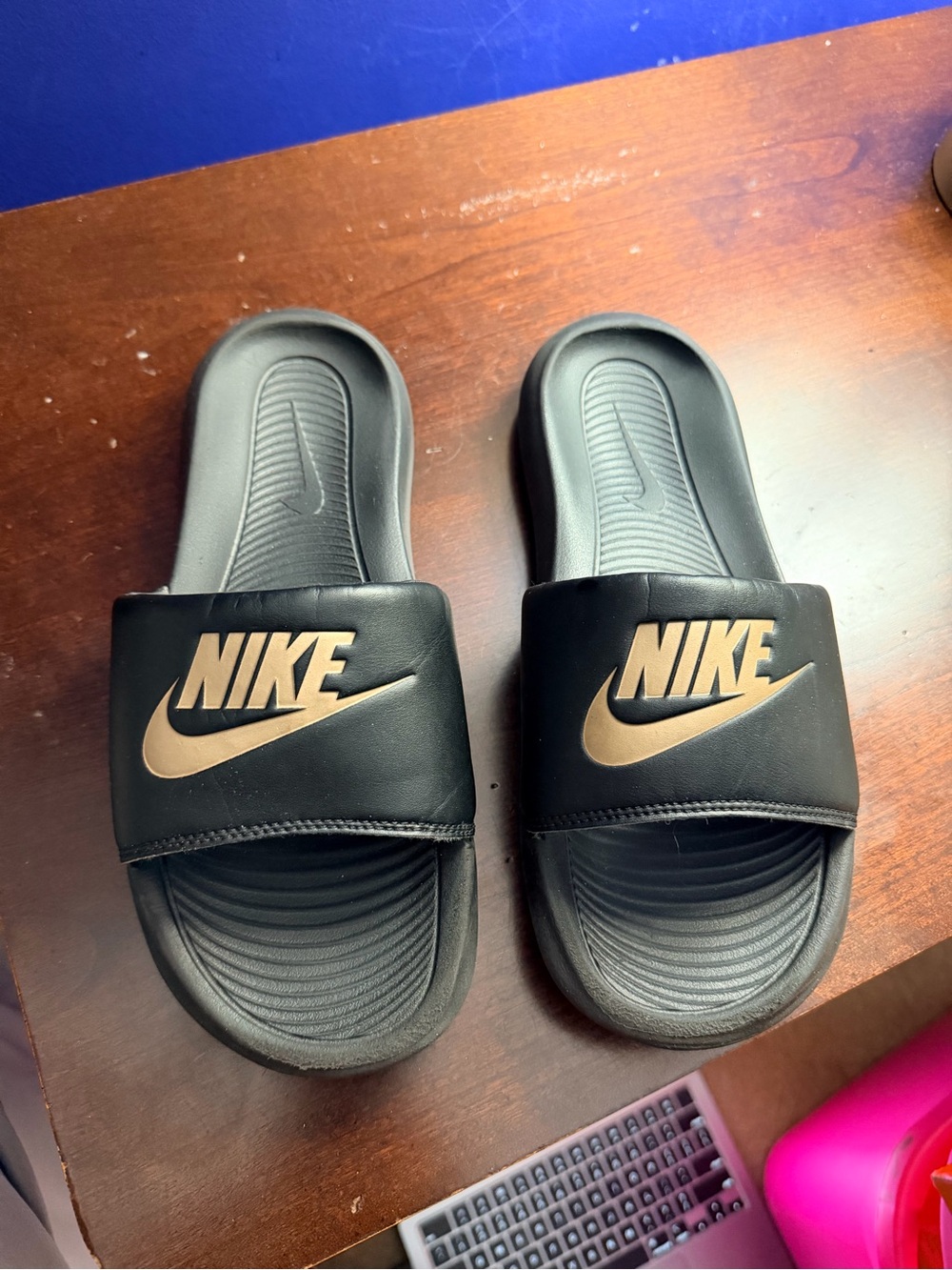 Nike Black Slides with Metallic Gold Logo